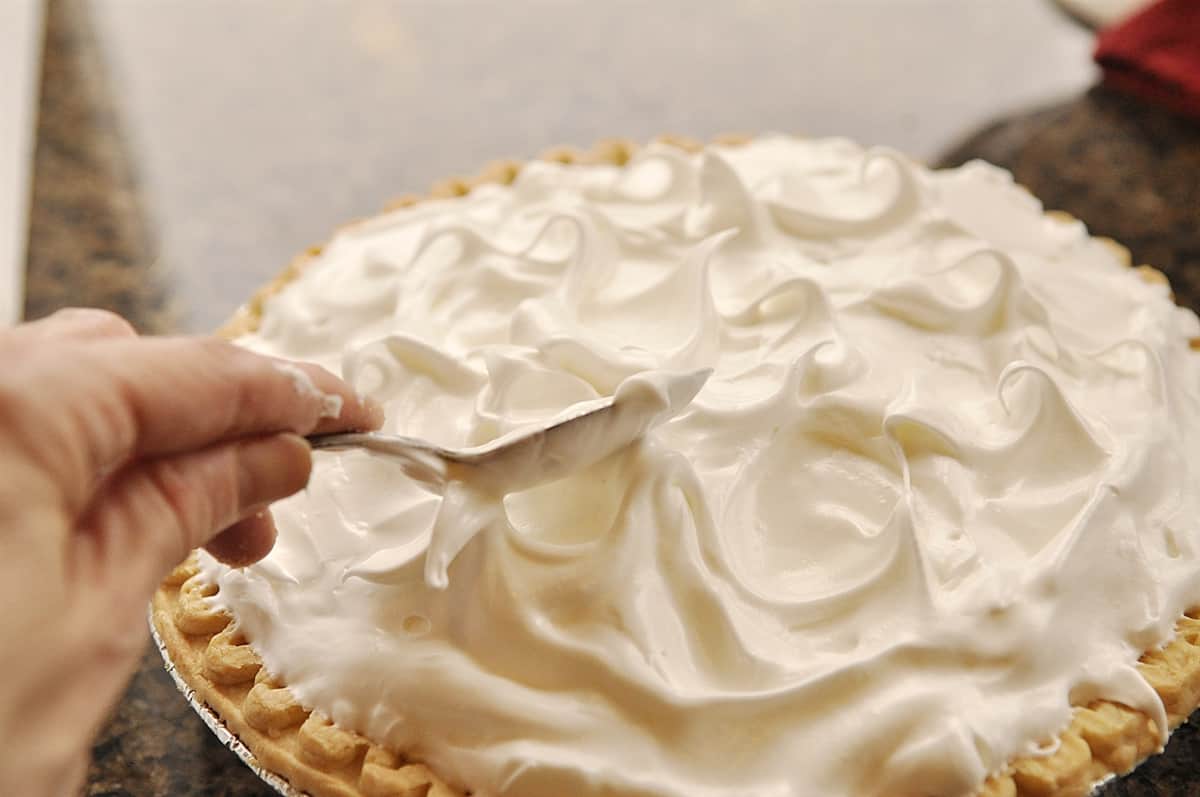 smoothing meringue on a pie