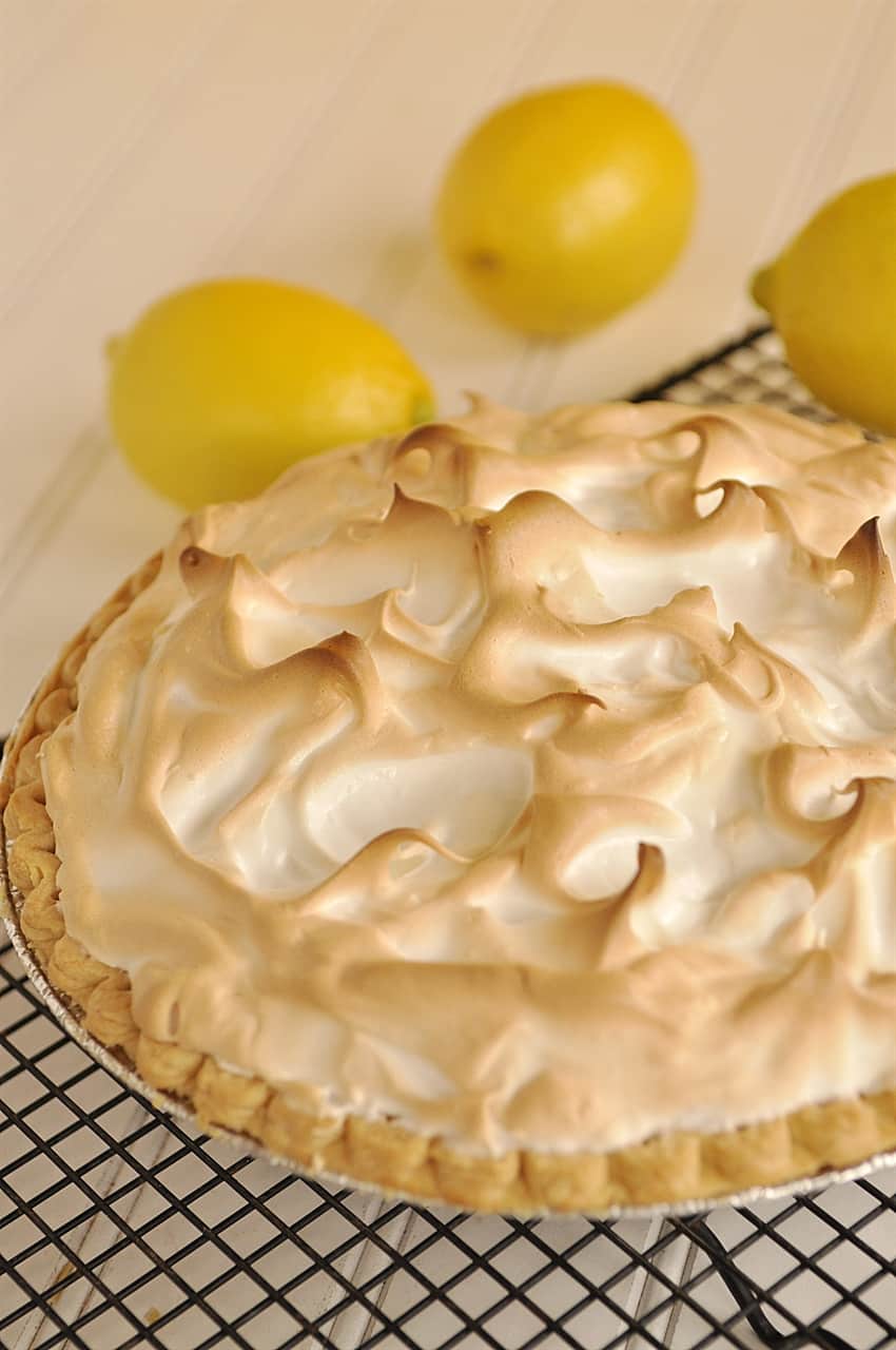 lemon meringue pie on a cooling rack
