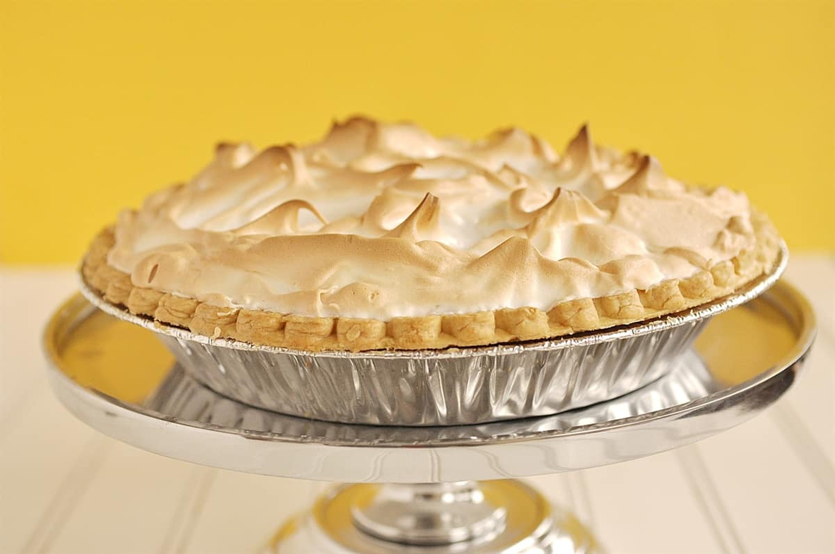 lemon meringue pie on a pie stand