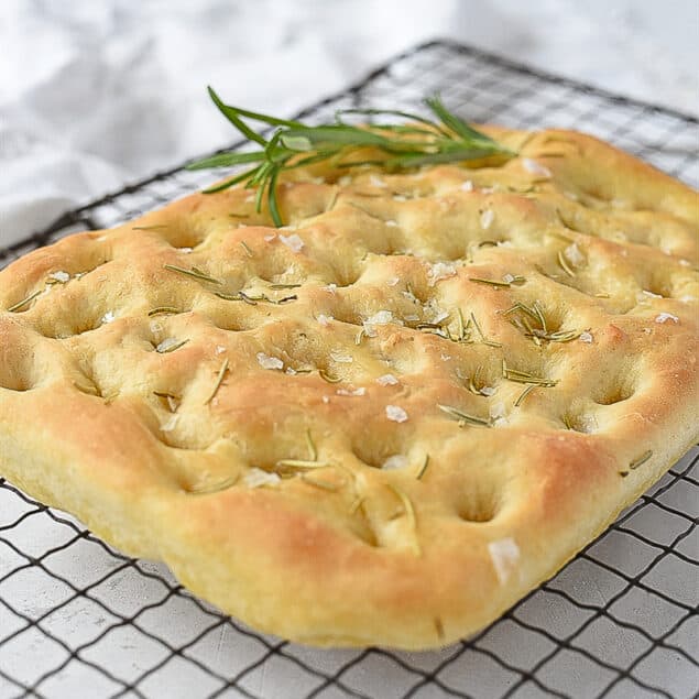 loaf of focaccia bread on a cooling rack