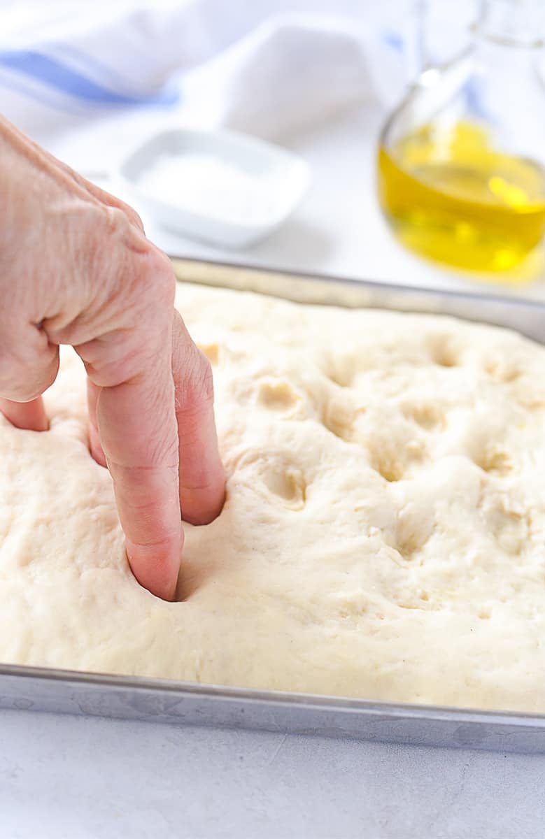 dimpling focaccia bread dough