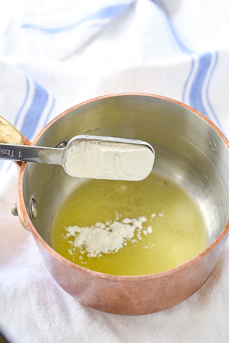 adding flour to butter in a pan