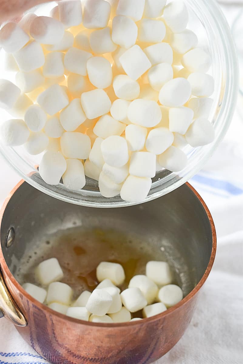 adding marshmallows to butter