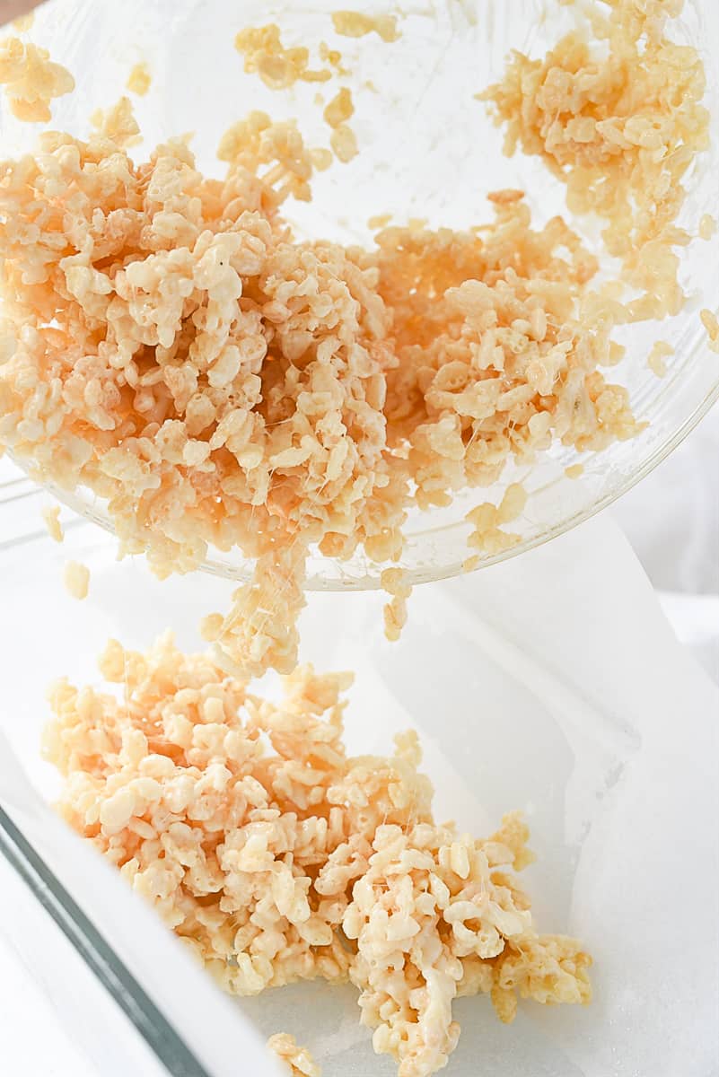 POURING RICE KRISPIE TREATS INTO PAN