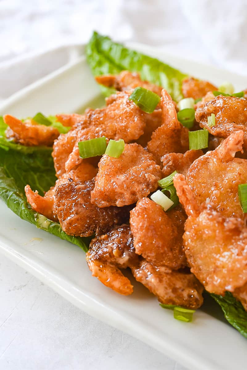 firecracker shrimp on a bed of lettuce