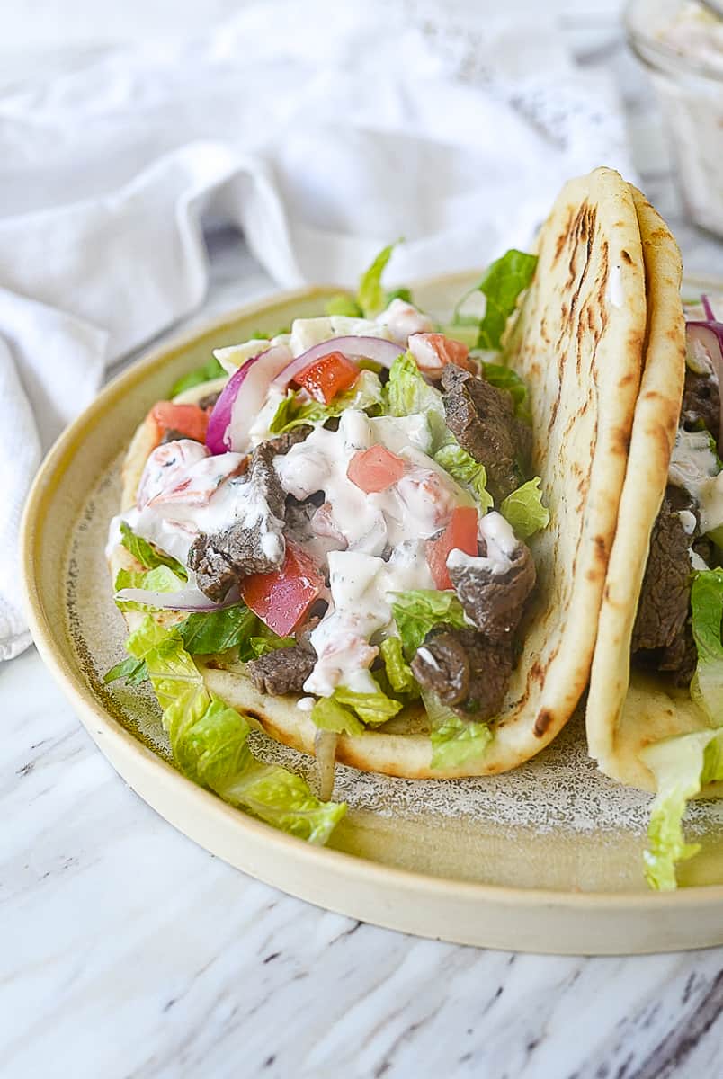 beef gyro with sauce on it