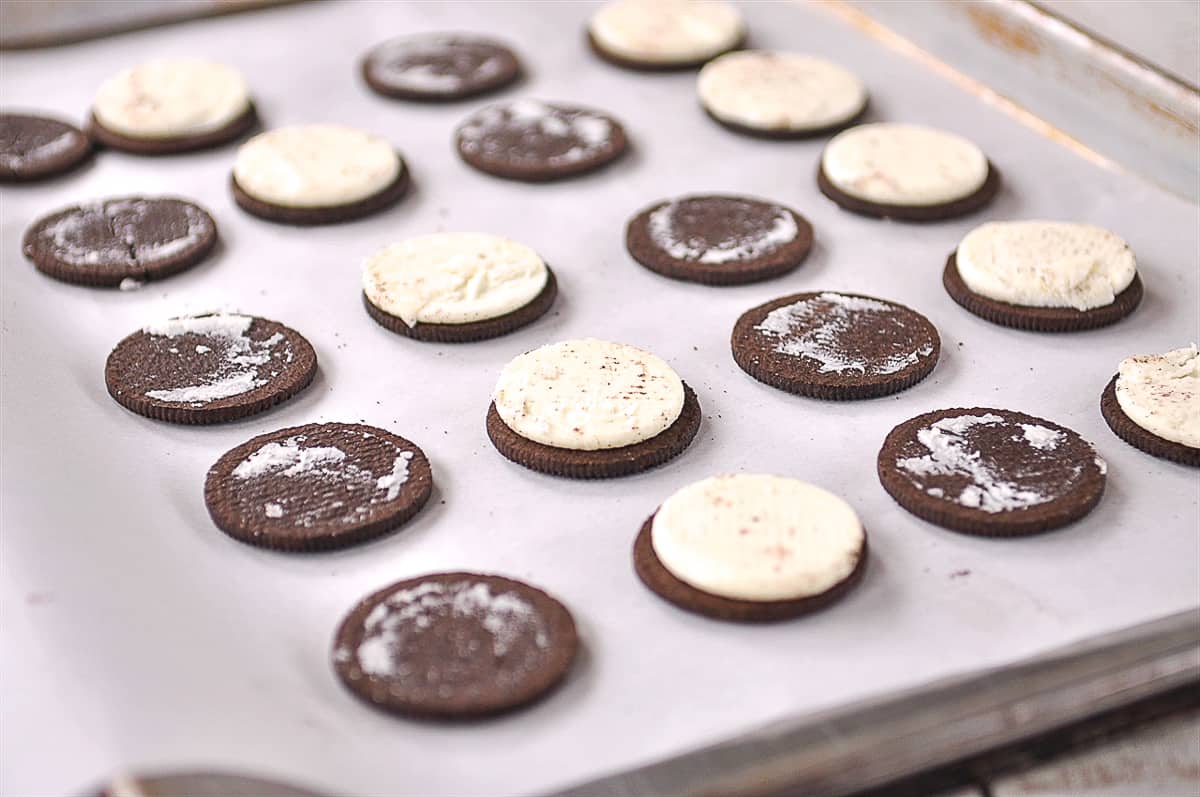 oreos broken in half on sheet pan