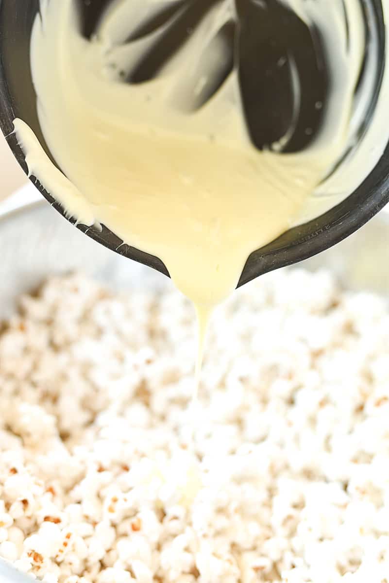 pouring chocolate over popcorn