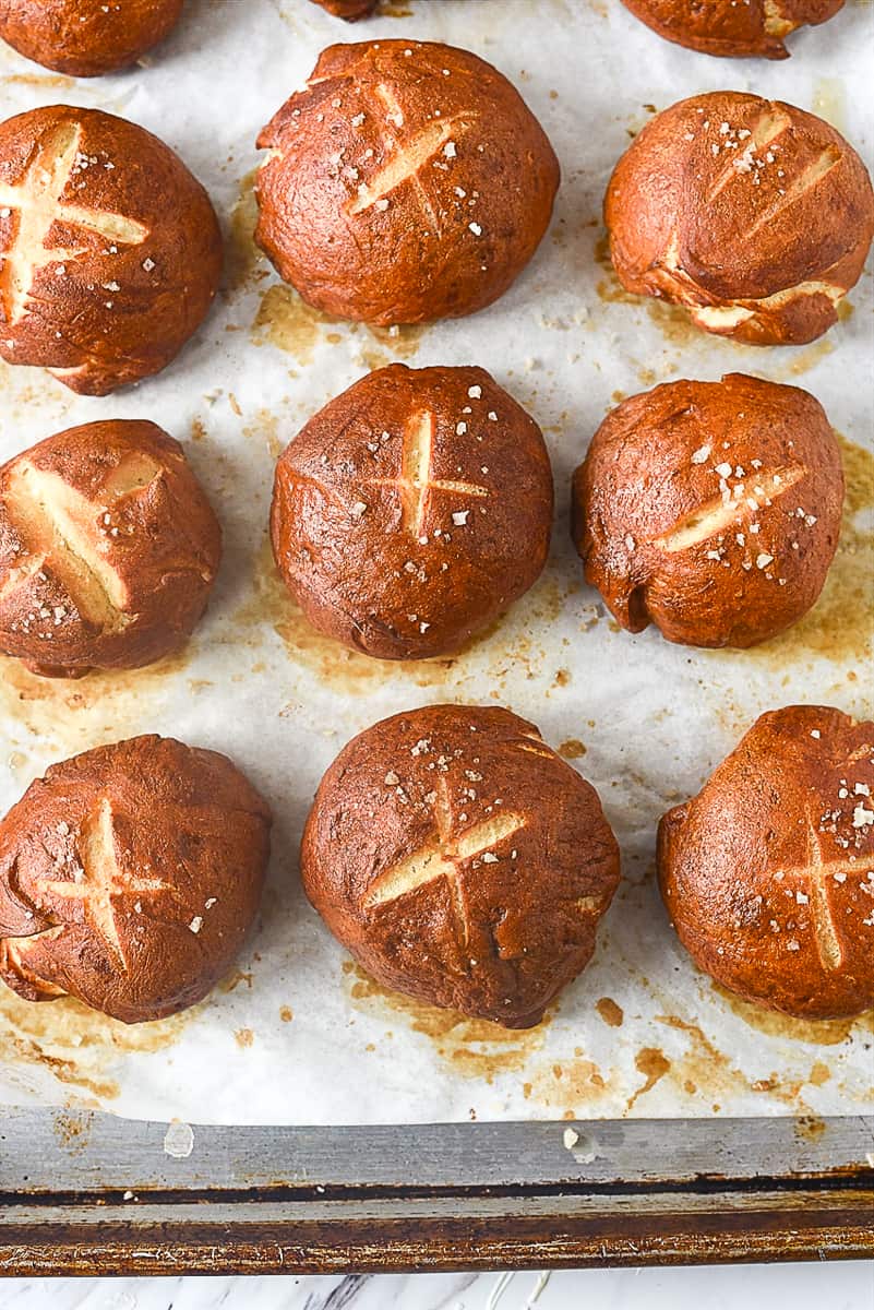  baked pretzel rolls on baking sheet