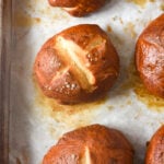 pretzel rolls on a baking sheet