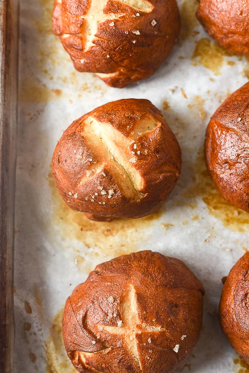 pretzel rolls on a baking sheet