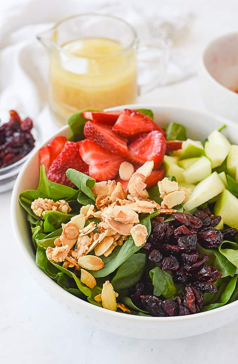 spinach fruit salad ingredients in a bowl