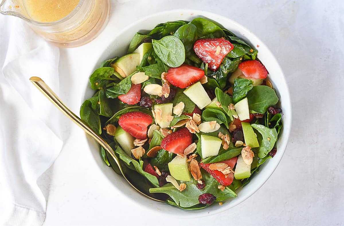 overhead of spinach fruit salad