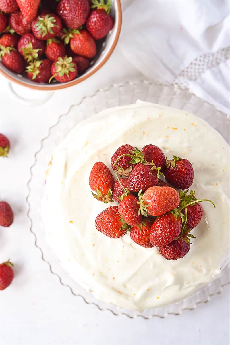 overhead shot of strawberry layer cake with strawberries on top