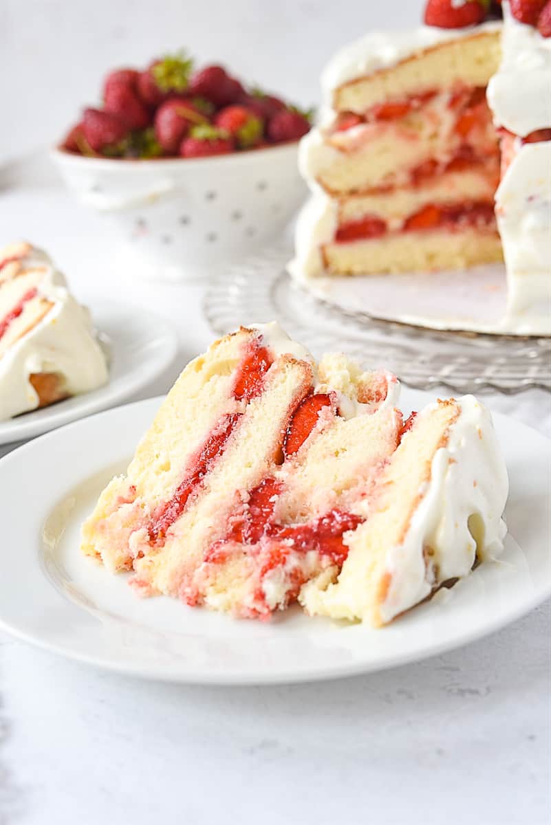 piece of strawberry layer cake frosted with 7 minute frosting