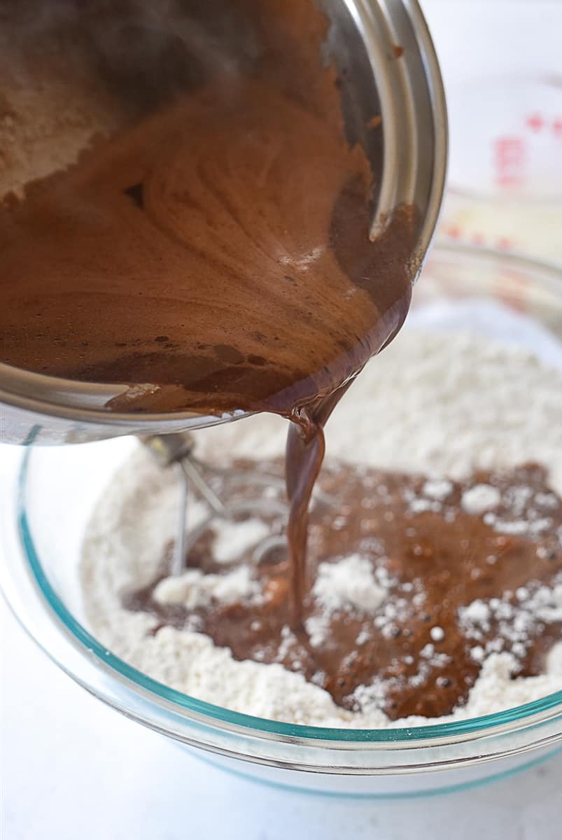 pouring chocolate mixture into flour