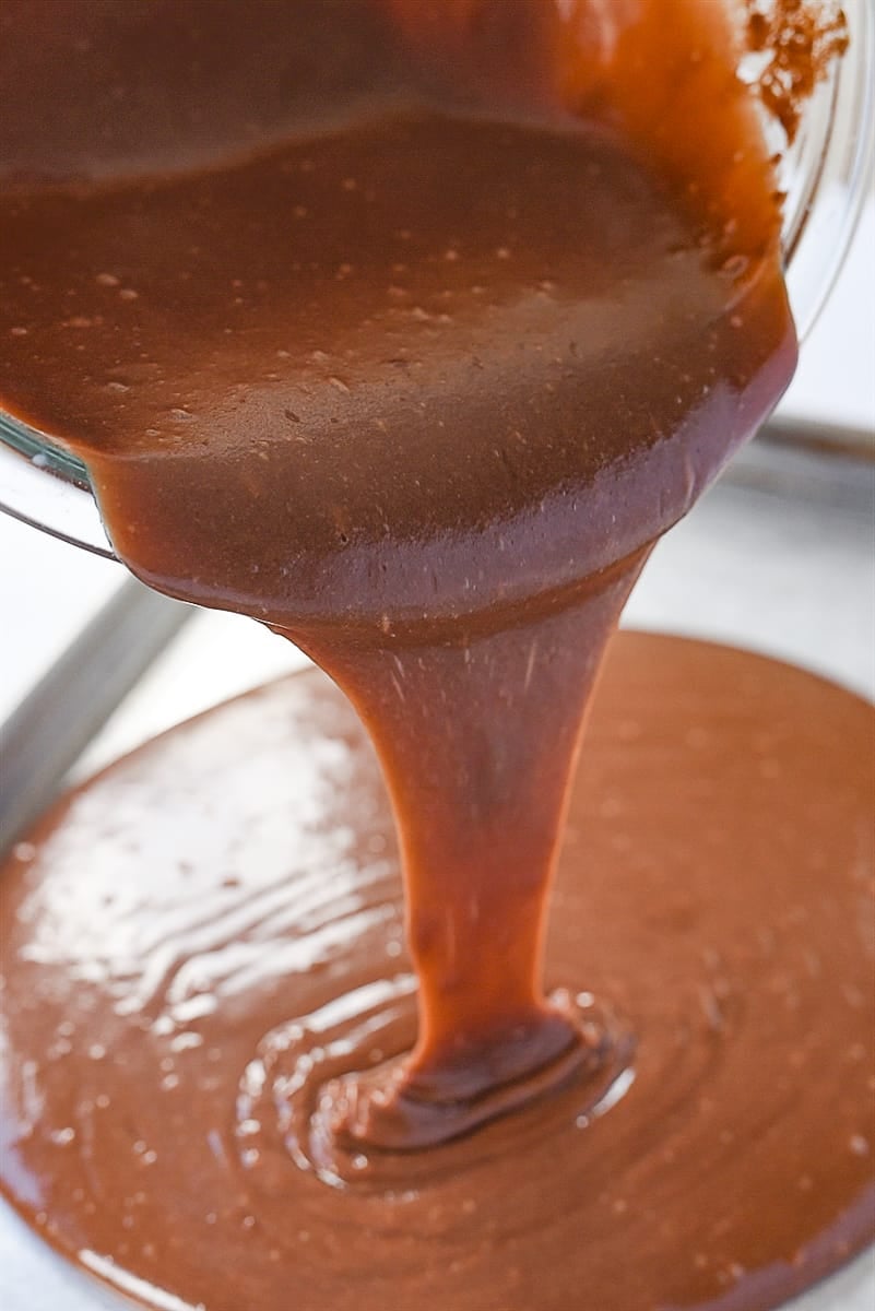 pouring cake batter into pan