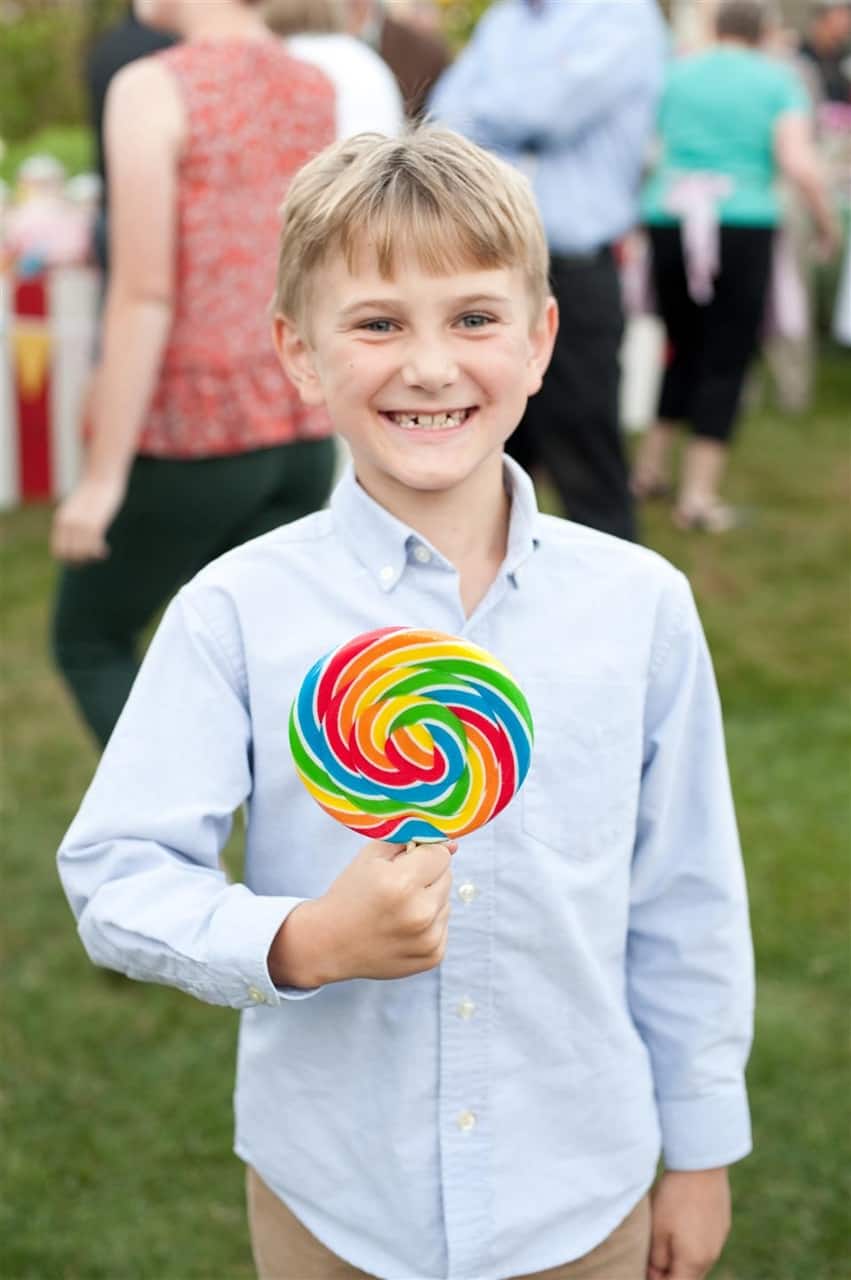 BOY HOLDING RAINBOW SUCKER