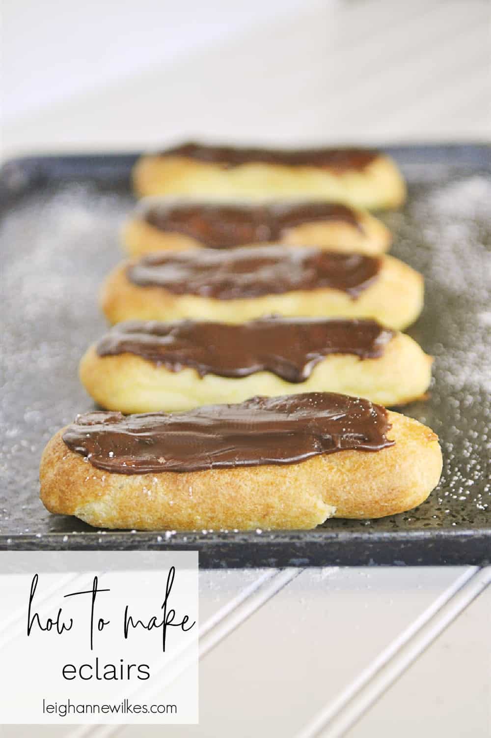 chocolate eclairs on a baking sheet