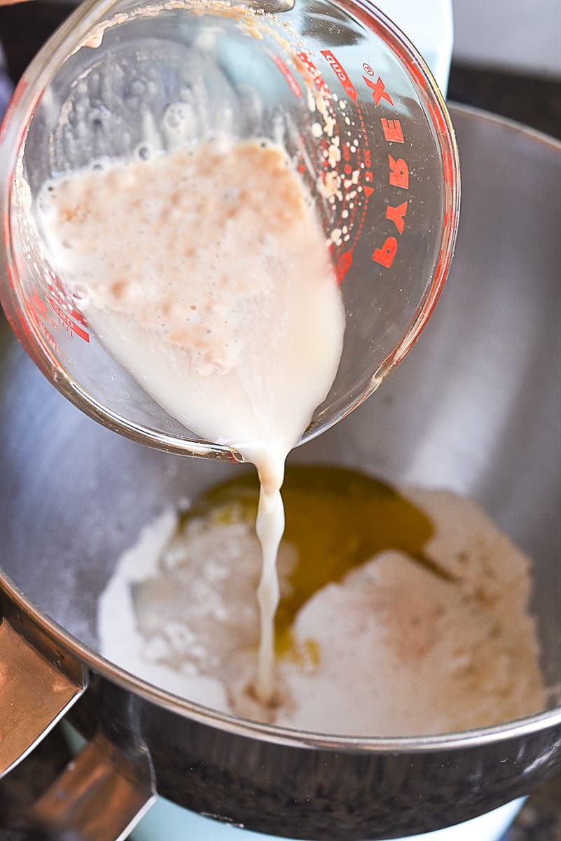 pouring yeast mixture into flour