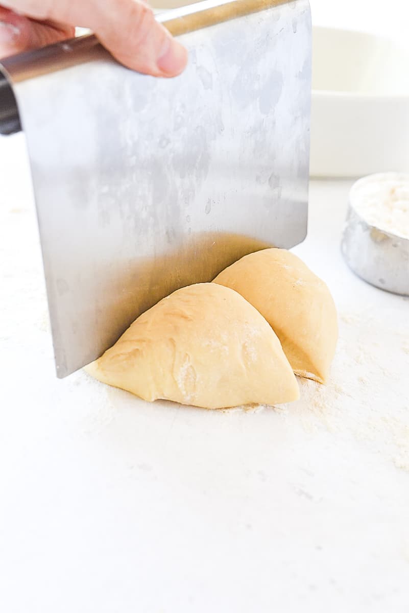 cutting dough into four pieces