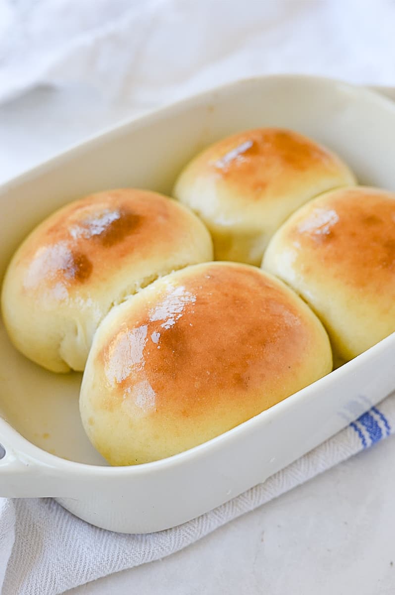 four baked rolls in a pan