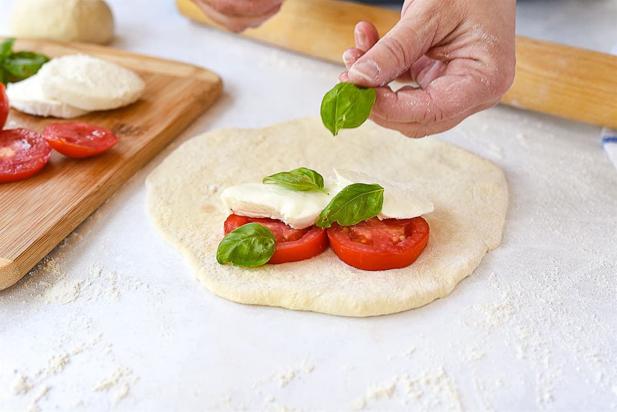 putting ingredients on calzone