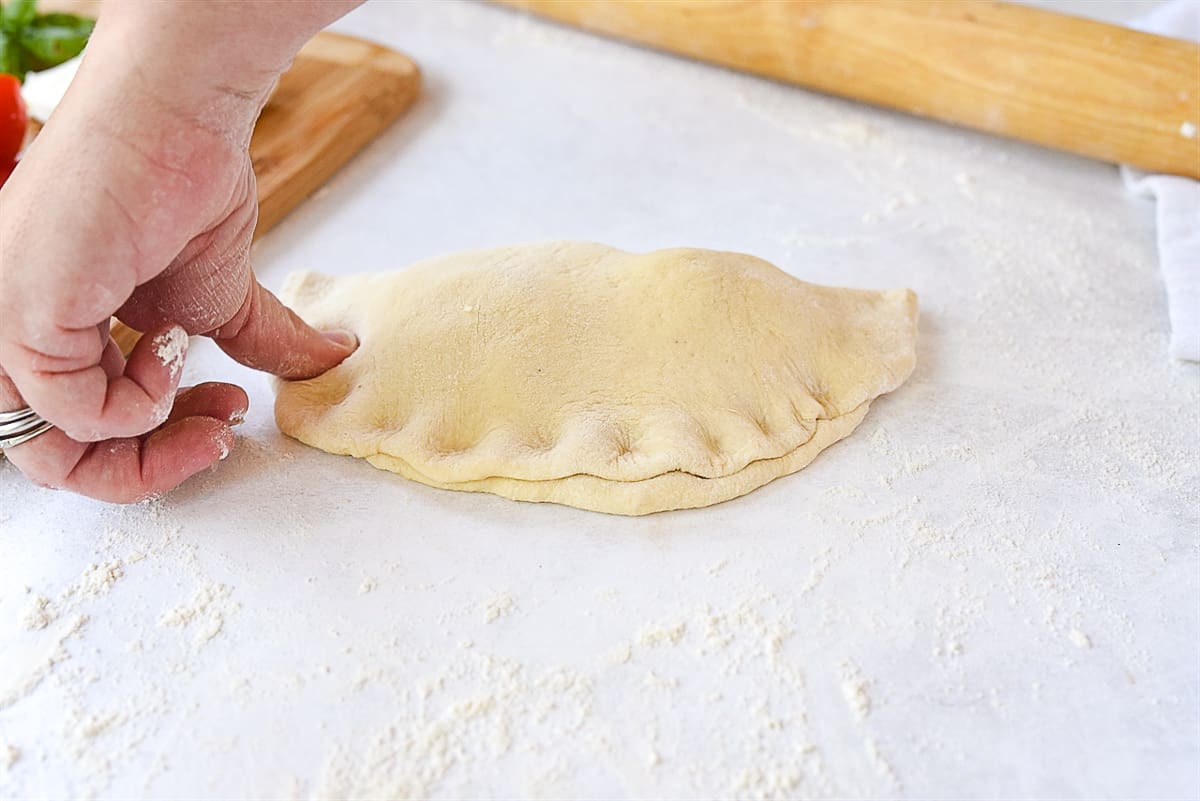 pushing dough down with fingers