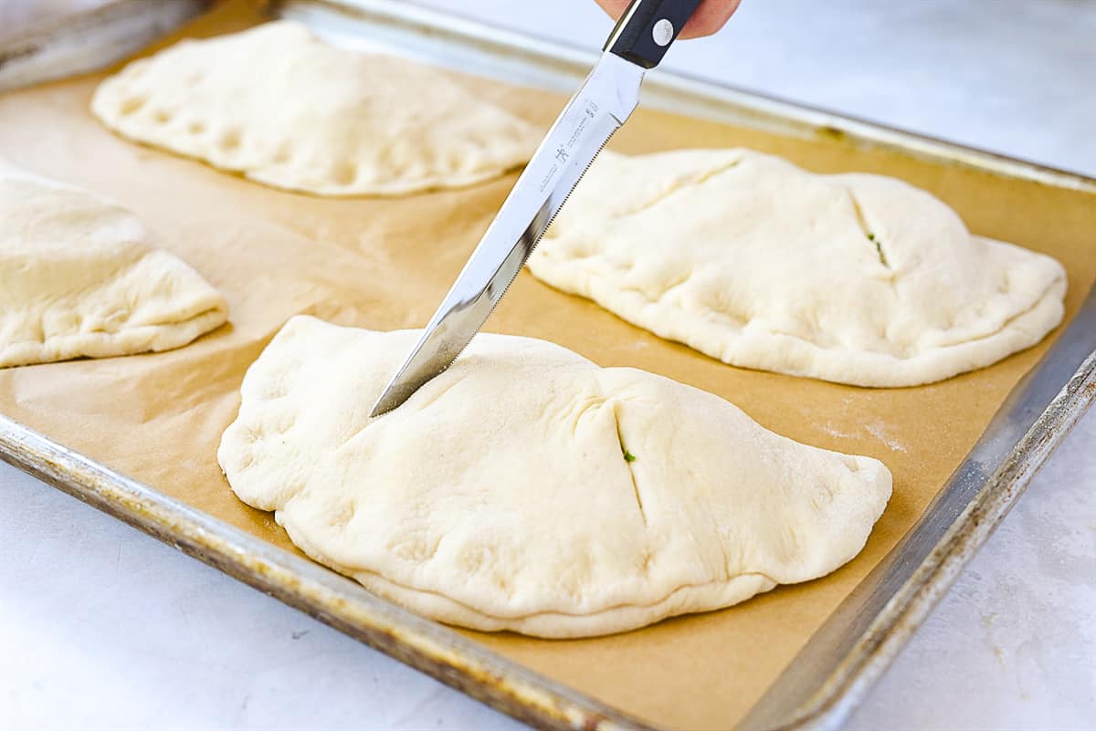 calzones on baking sheet