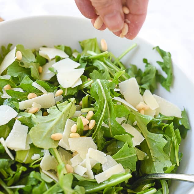 adding nuts to salad