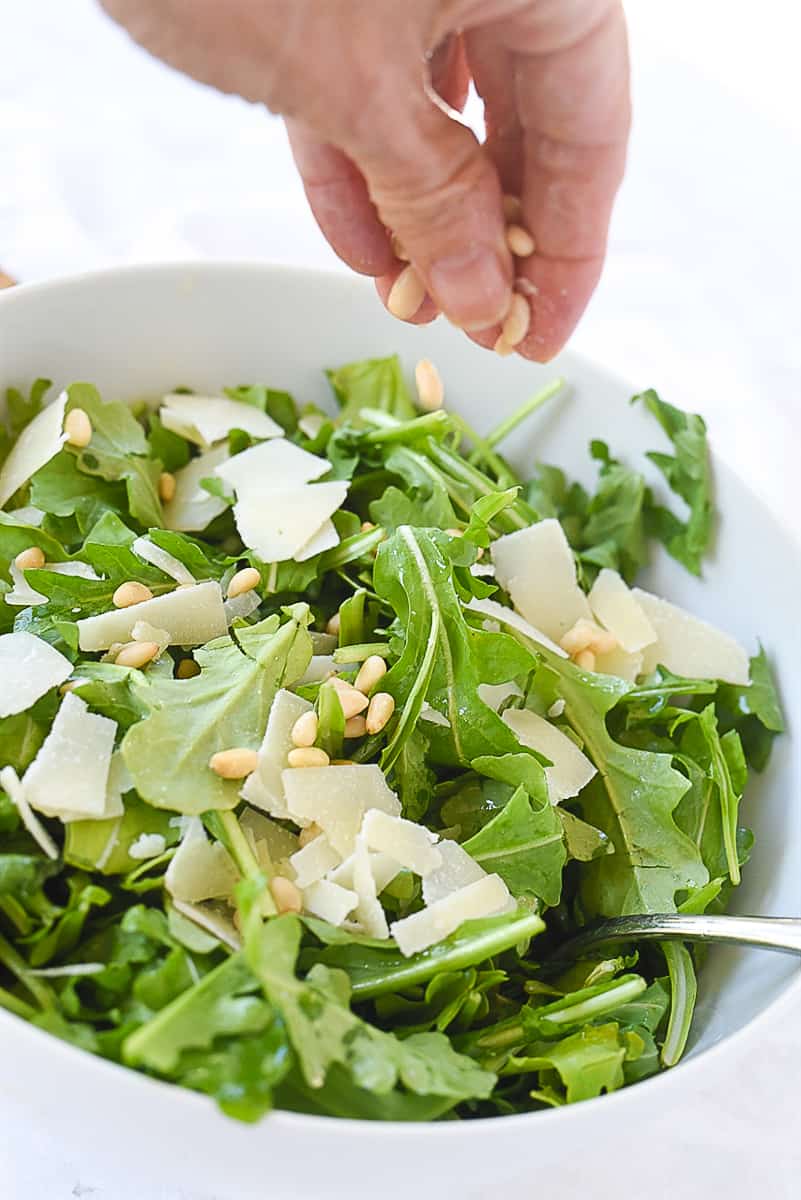 adding nuts to salad