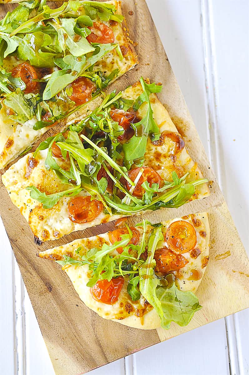 overhead shot of arugula pizza salad