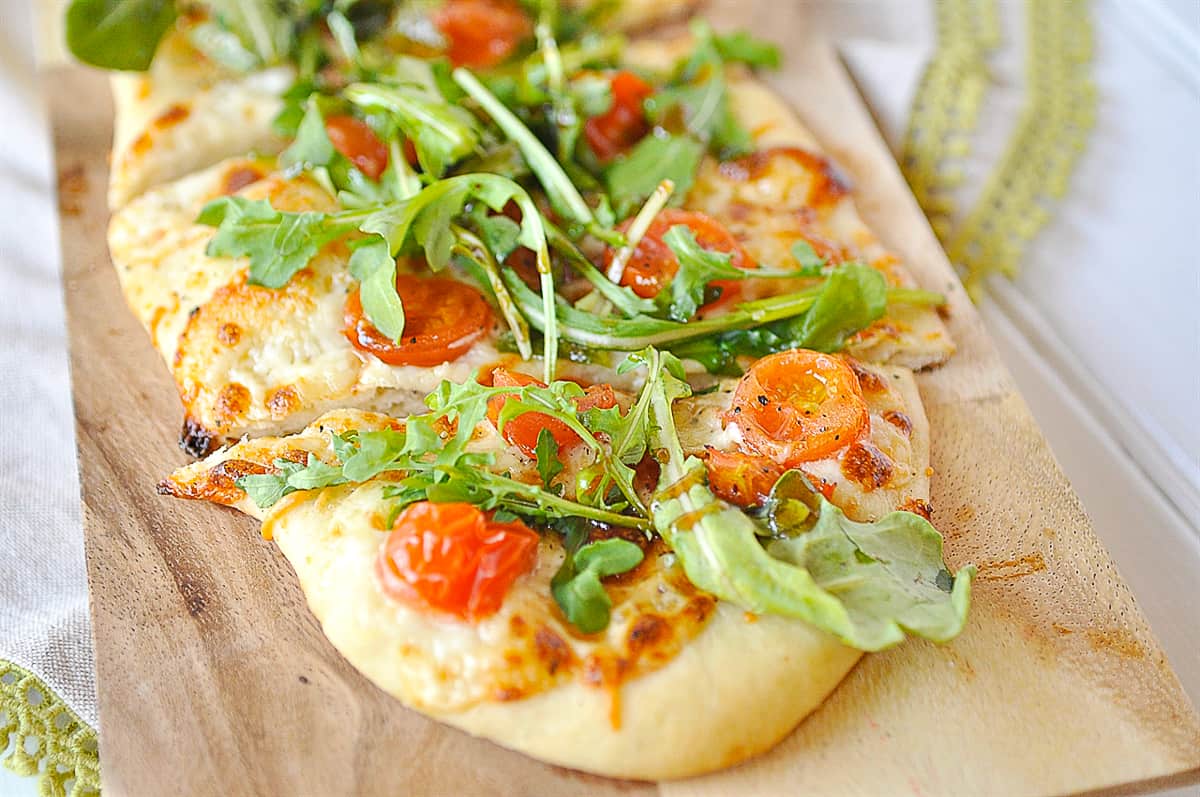 close up of arugula salad pizza