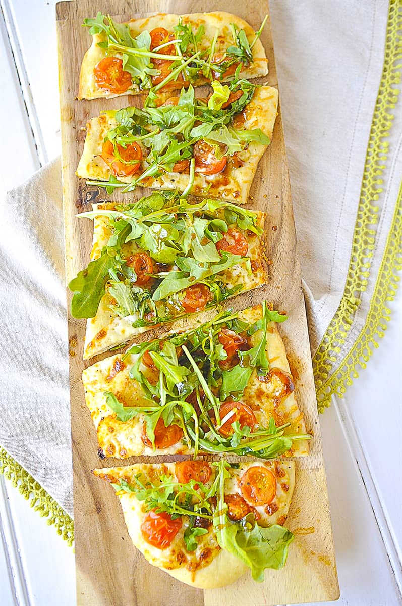 overhead shot of pizza arugula salad