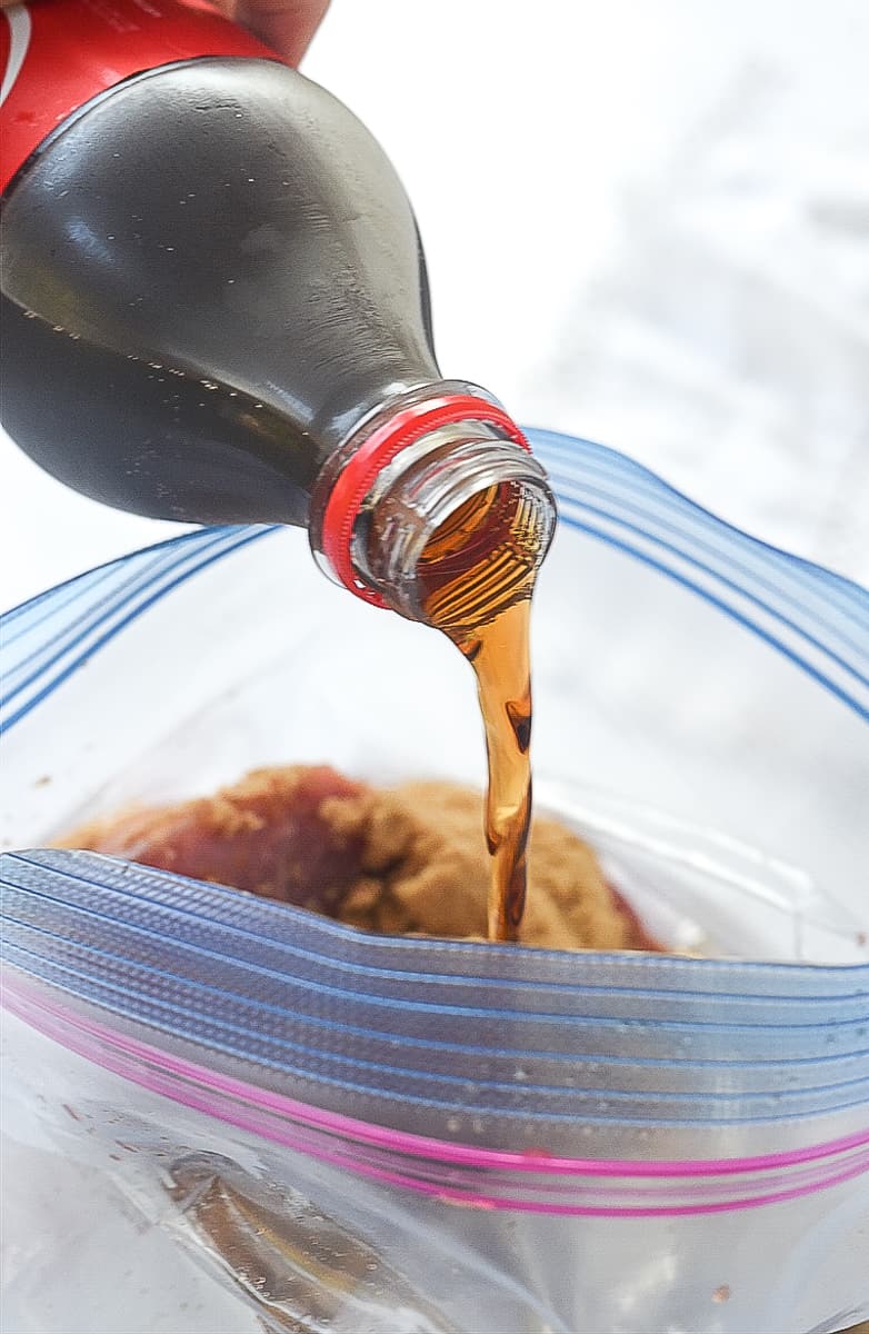 pouring coke into  marinade bag