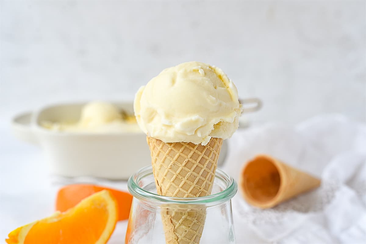 orange creamsicle ice cream on a cone