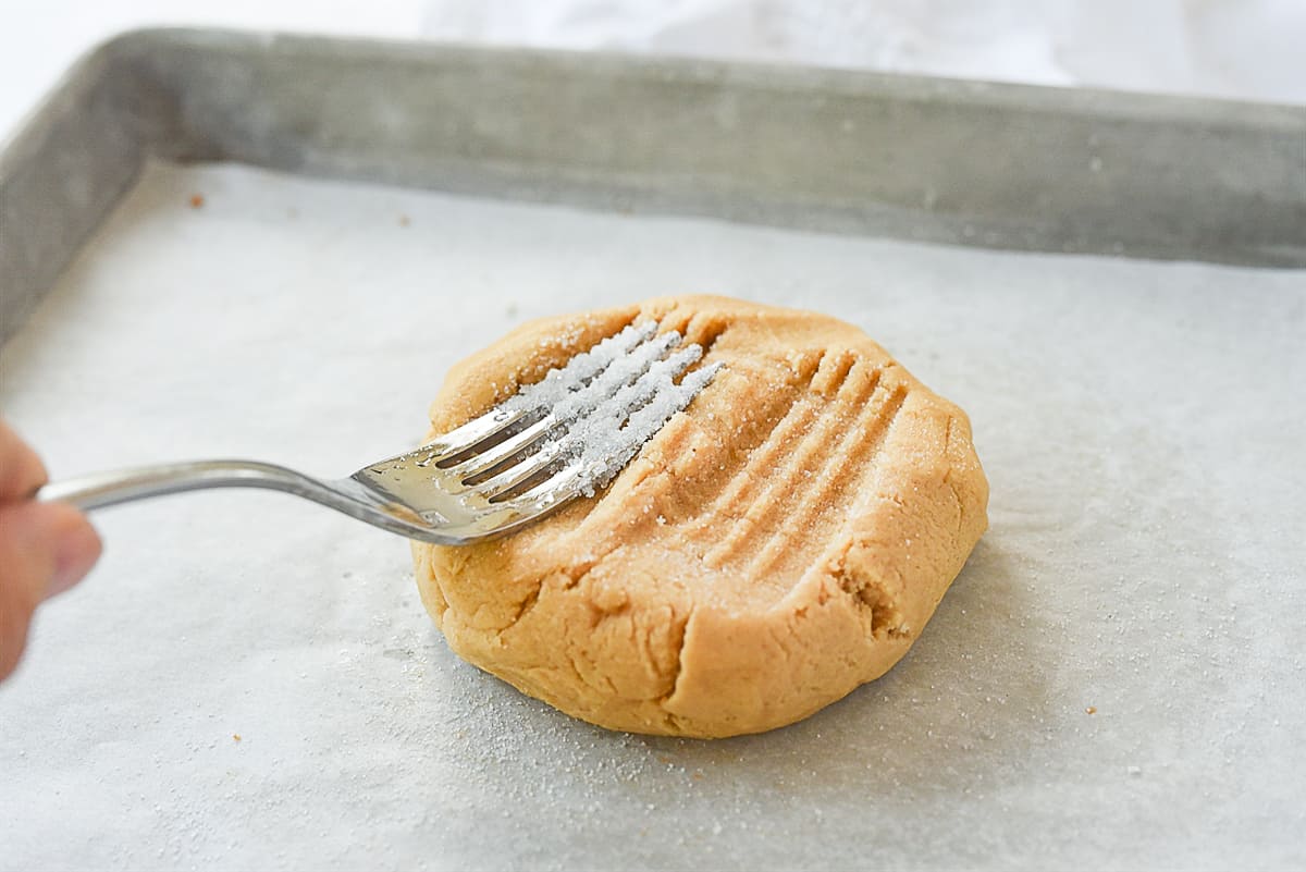 fork pressing into cookie