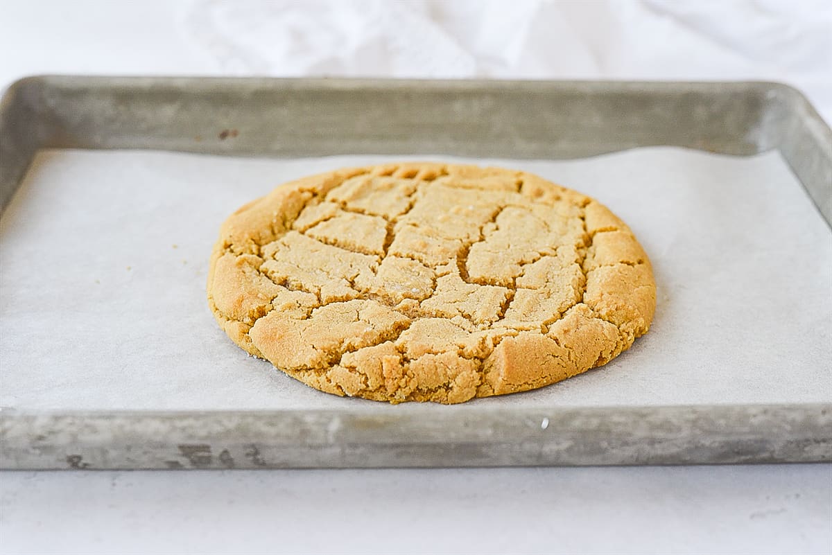 giant peanut butter cookie on baking sheet