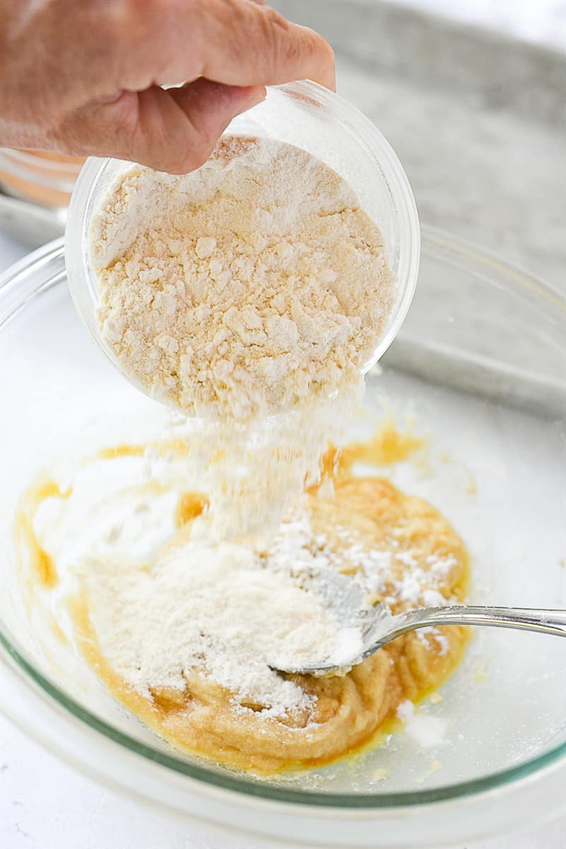 adding flour to snickerdoodle dough