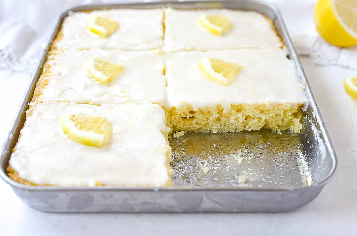 lemon sheet cake with a piece missing