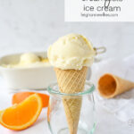 SCOOp of creamsicle ice cream on a cone