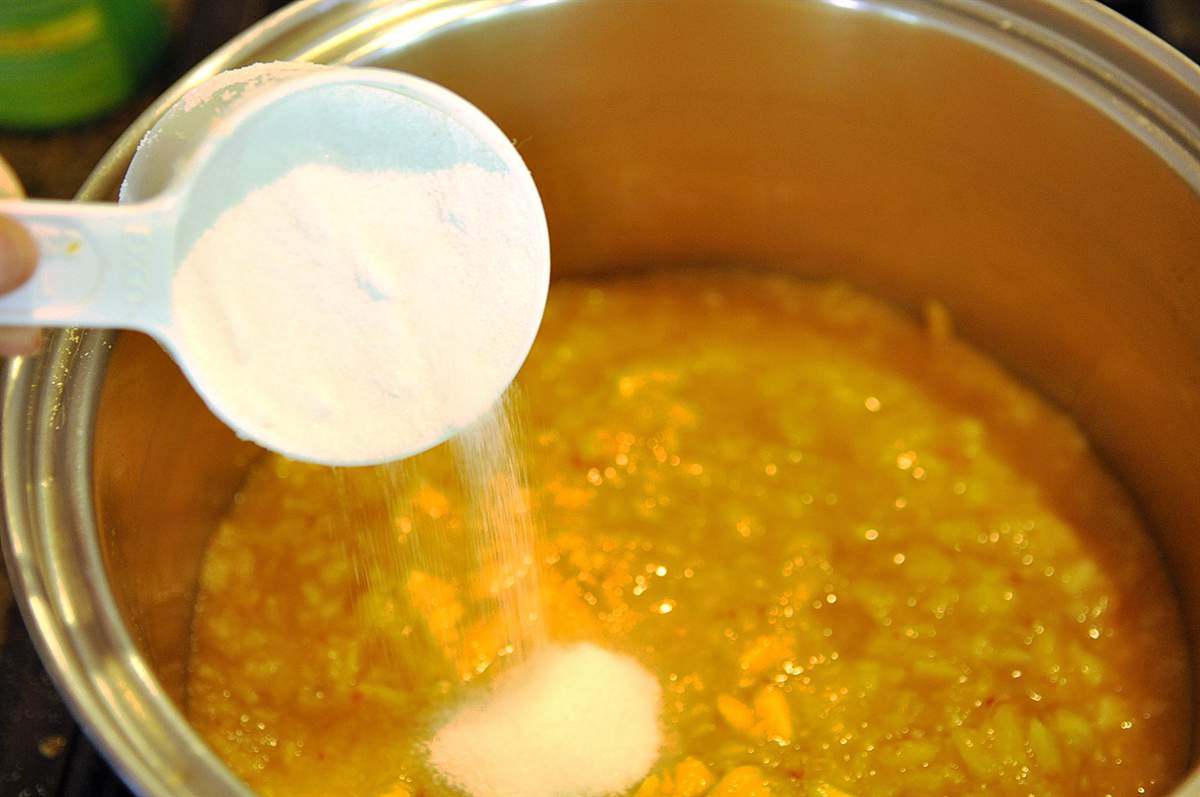 pouring sugar into jam