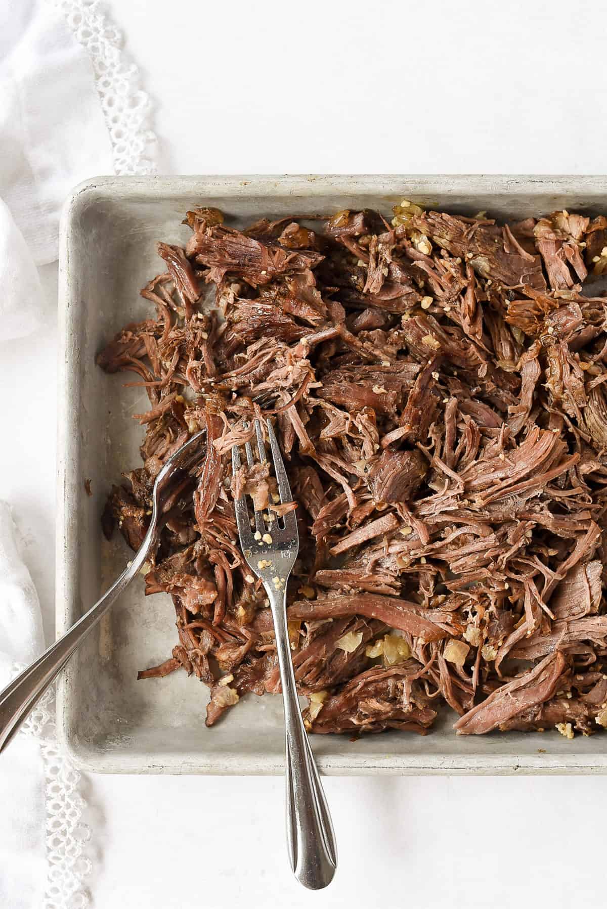 shredded meat on cookie sheet