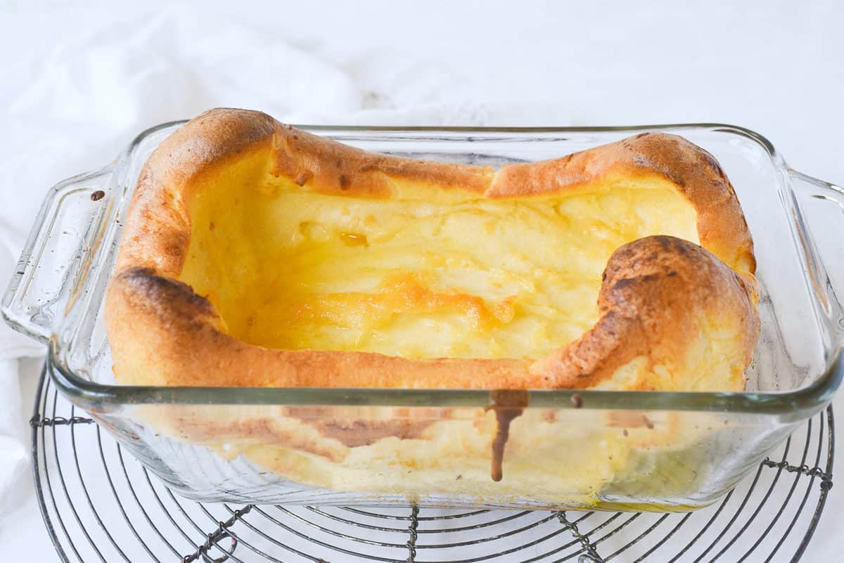 side view of a dutch baby in a glass pan
