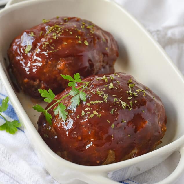 two mini meatloaf in a dish