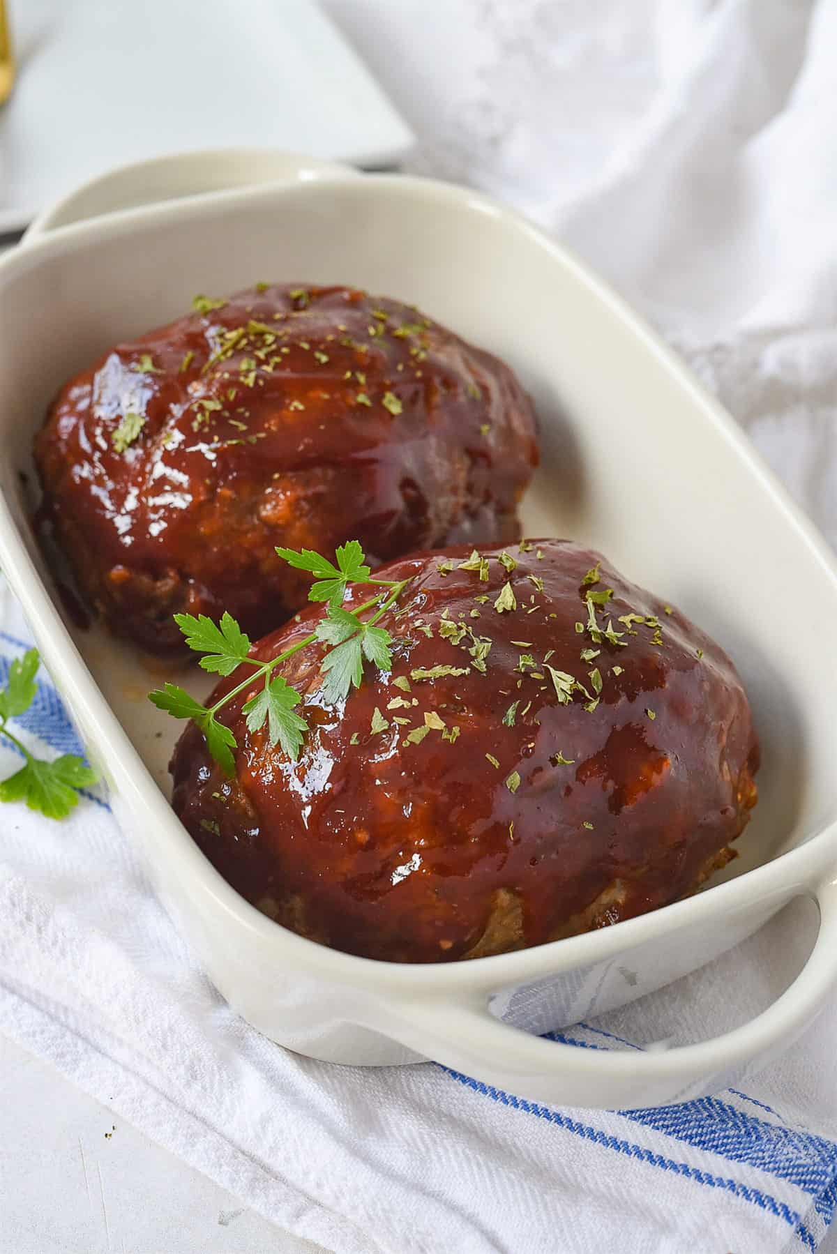 two mini meatloaf in a dish