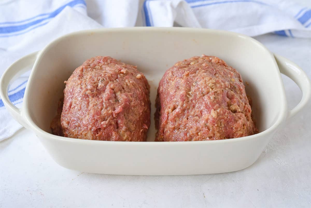 two mini meatloafs in a dish