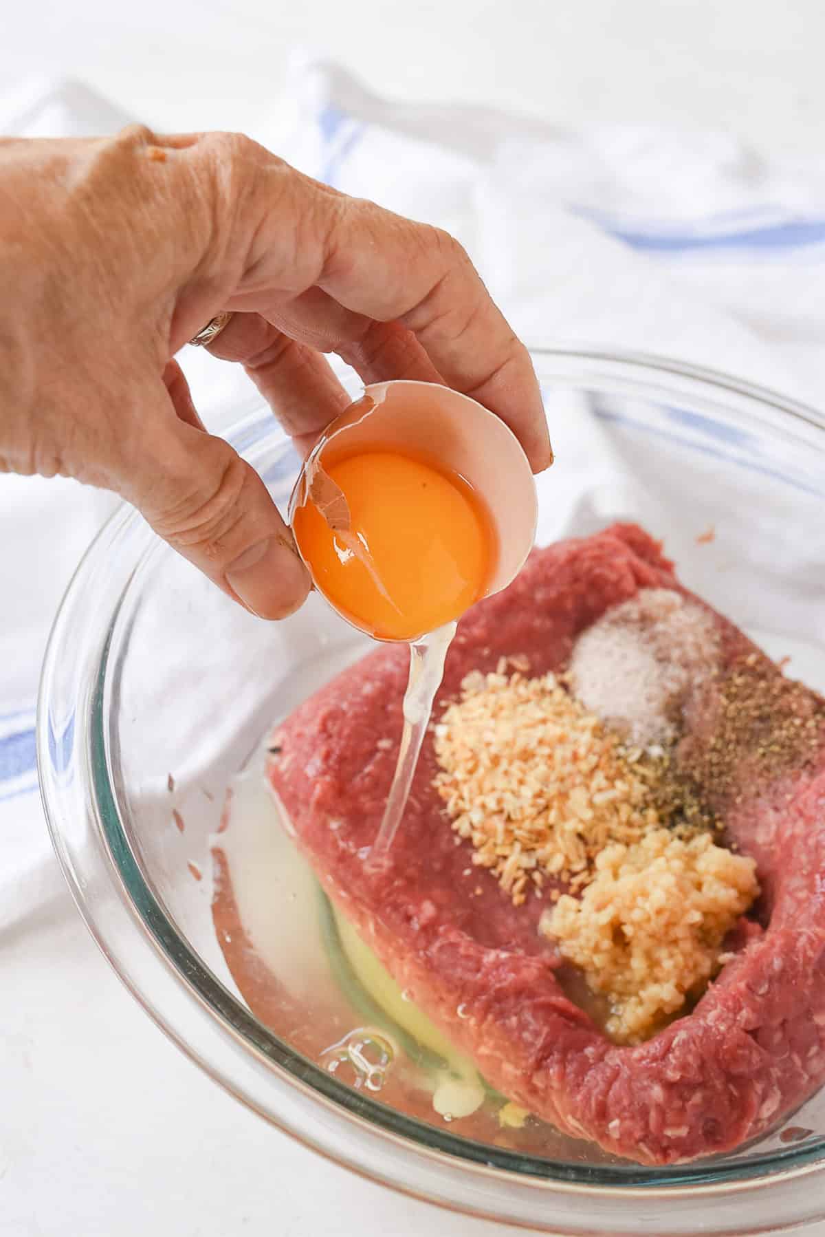 adding egg to meatloaf mixture