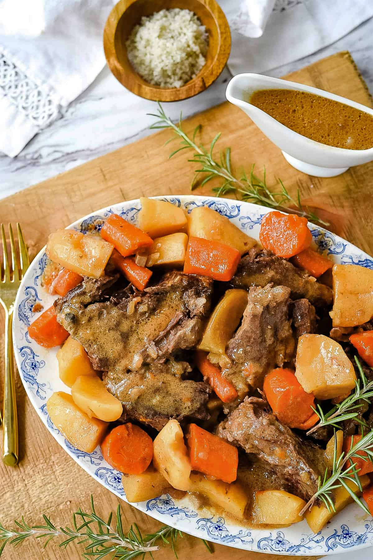 pot roast, carrots and potatoes on a serving platter