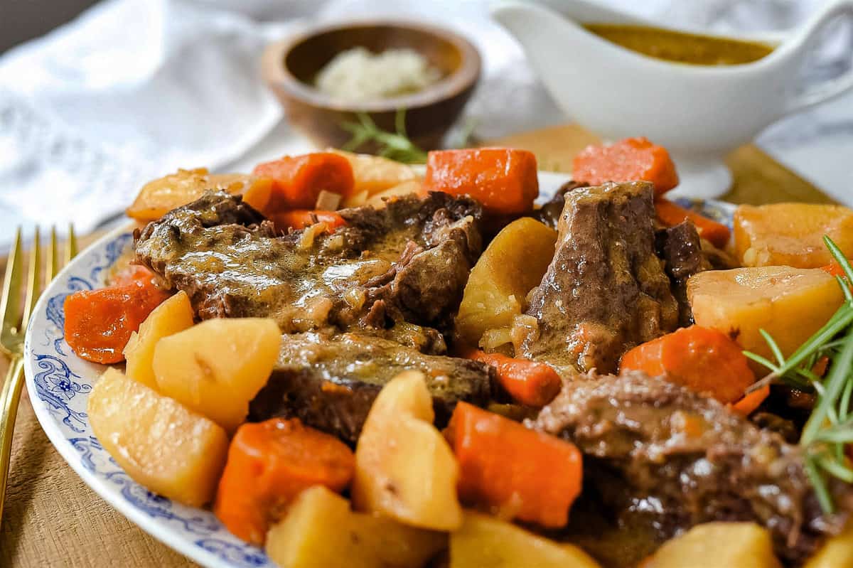 serving platter with meat, potatoes and carrots on it